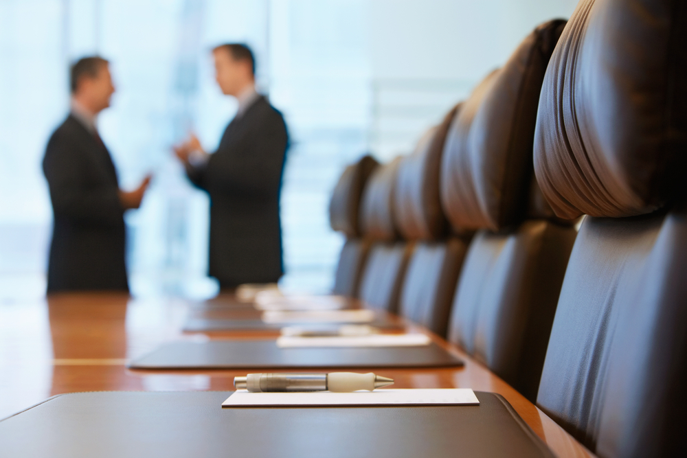 Two lawyers discuss a case in a conference room at a Bloomingdale FL Law Firm